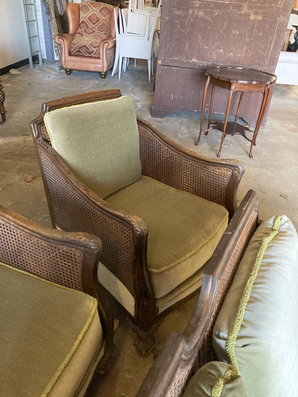 A 1920s carved beech four piece bergere suite